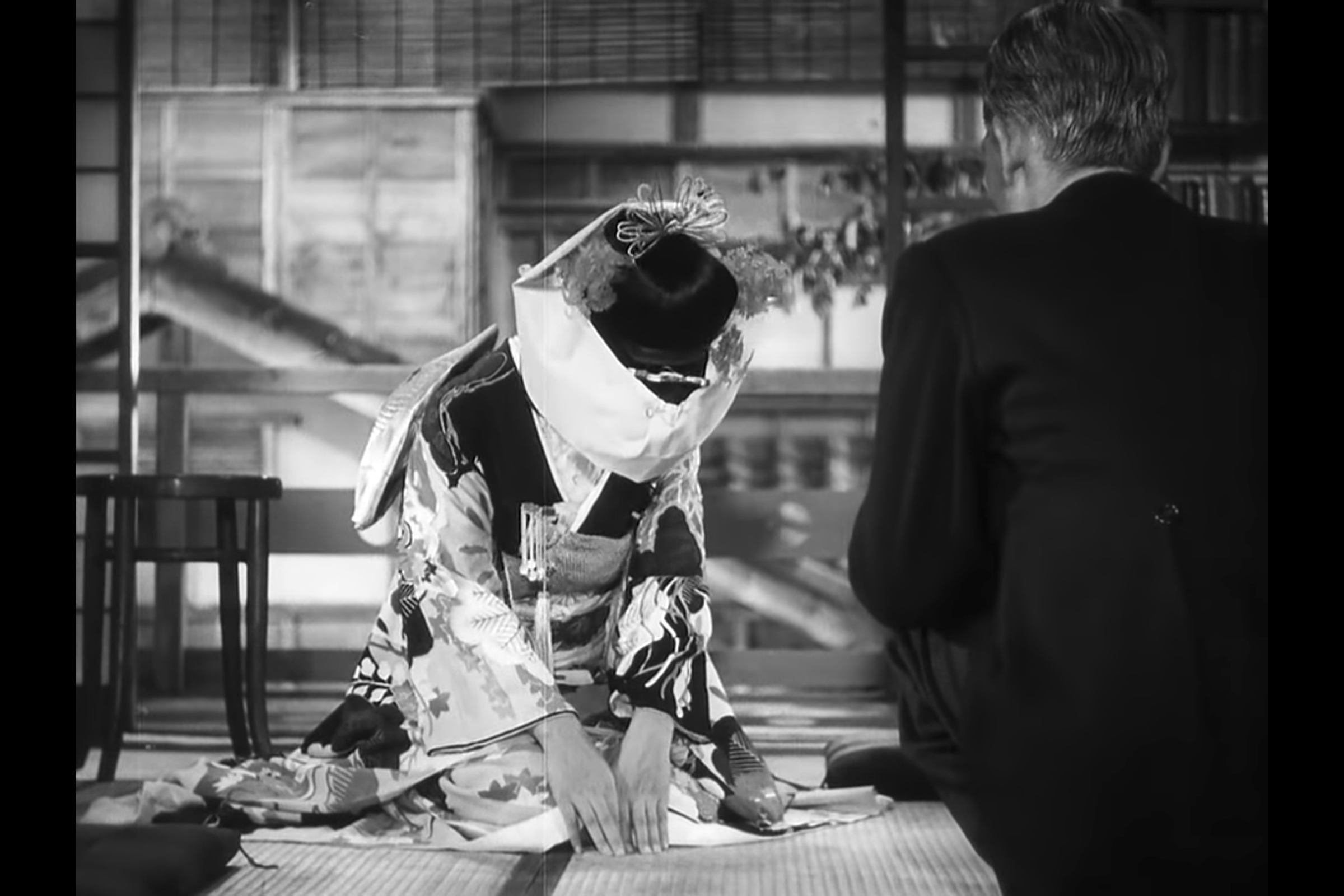 Beyond Ceremony: Noriko, beautifully dressed in a traditional wedding kimono, kneels and bows to her father to thank him for his care, just before she departs for the wedding.